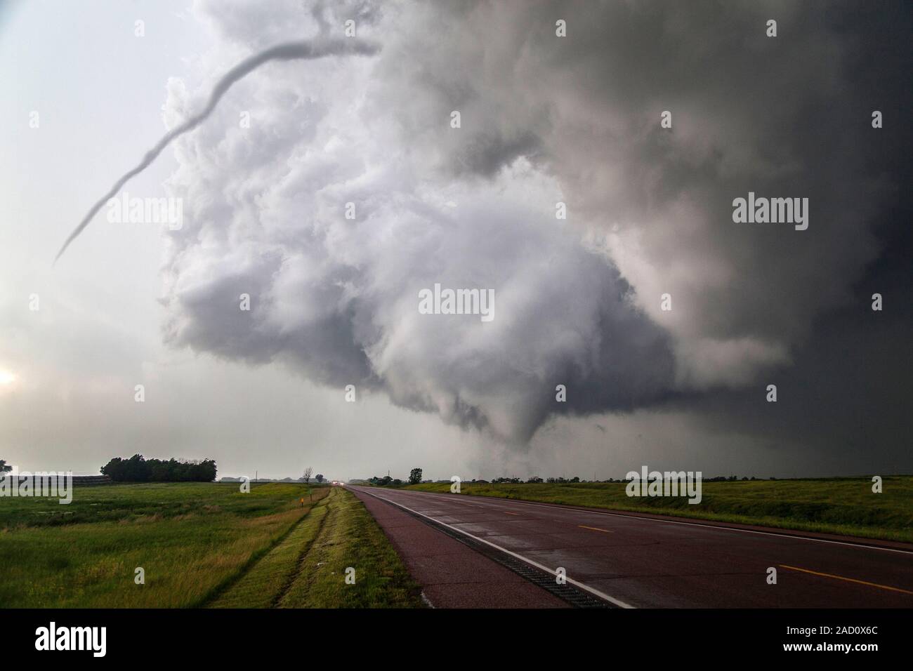 Twin tornados. View of two tornados over a road. A tornado is a violent