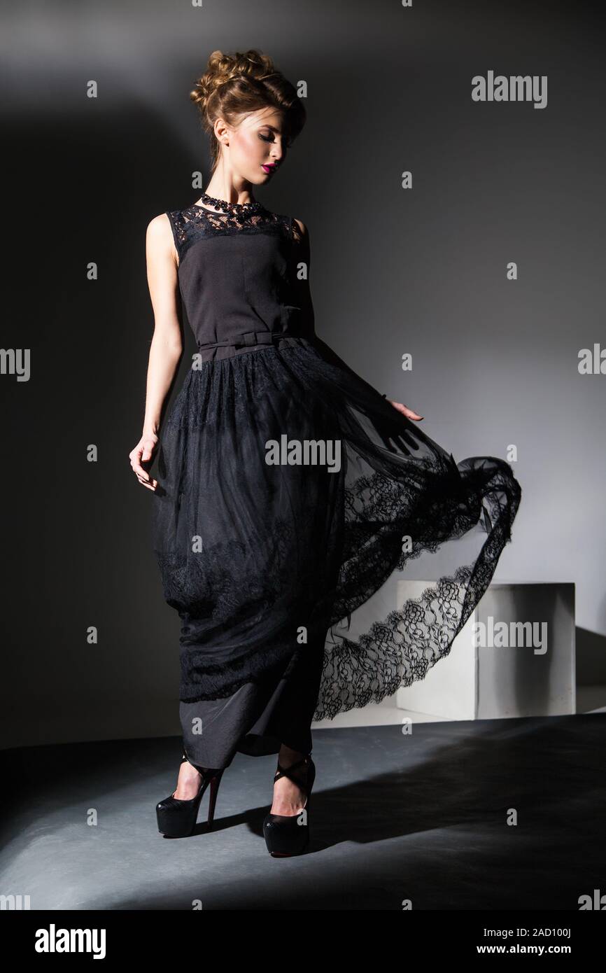 Beautiful model in black dress in motion Stock Photo - Alamy