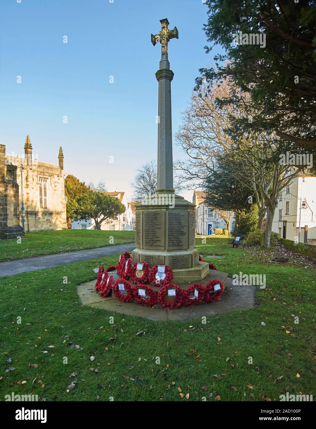 Wreaths of remembrance around the Cenotaph in the grounds of All Saints Church, Driffield, East Riding of Yorkshire, England, UK, GB. Stock Photo