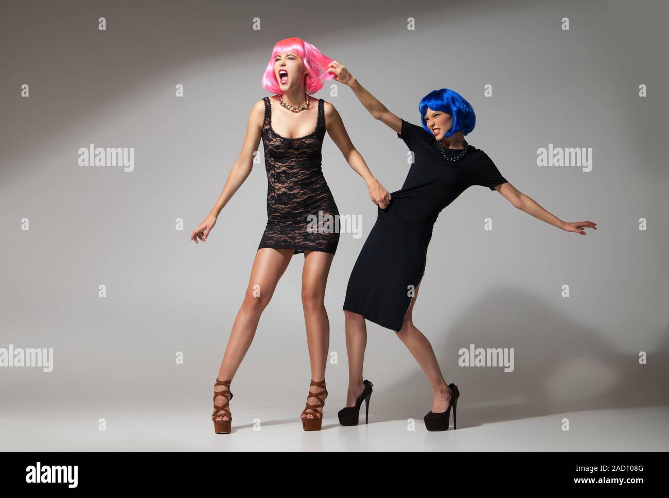 girl in black dress fight two women fighting for a dress Stock Photo
