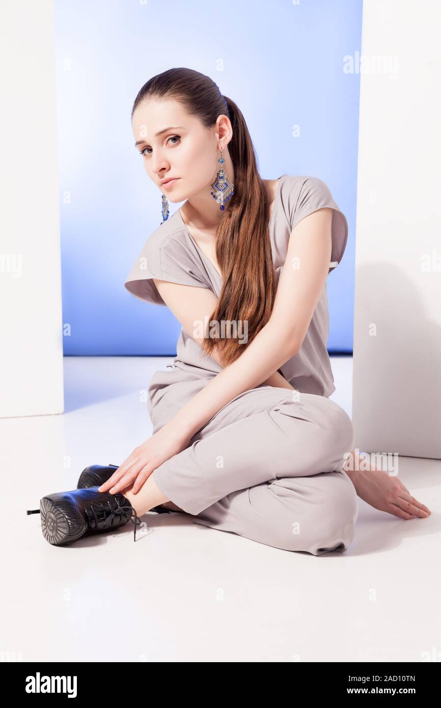 Stylish woman sitting on floor Stock Photo - Alamy