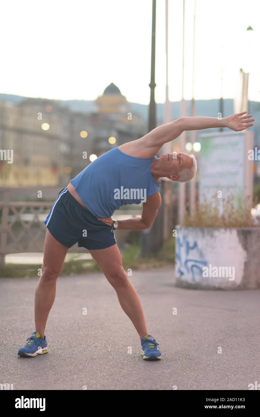 Handsome senior man stretching hi-res stock photography and images - Alamy