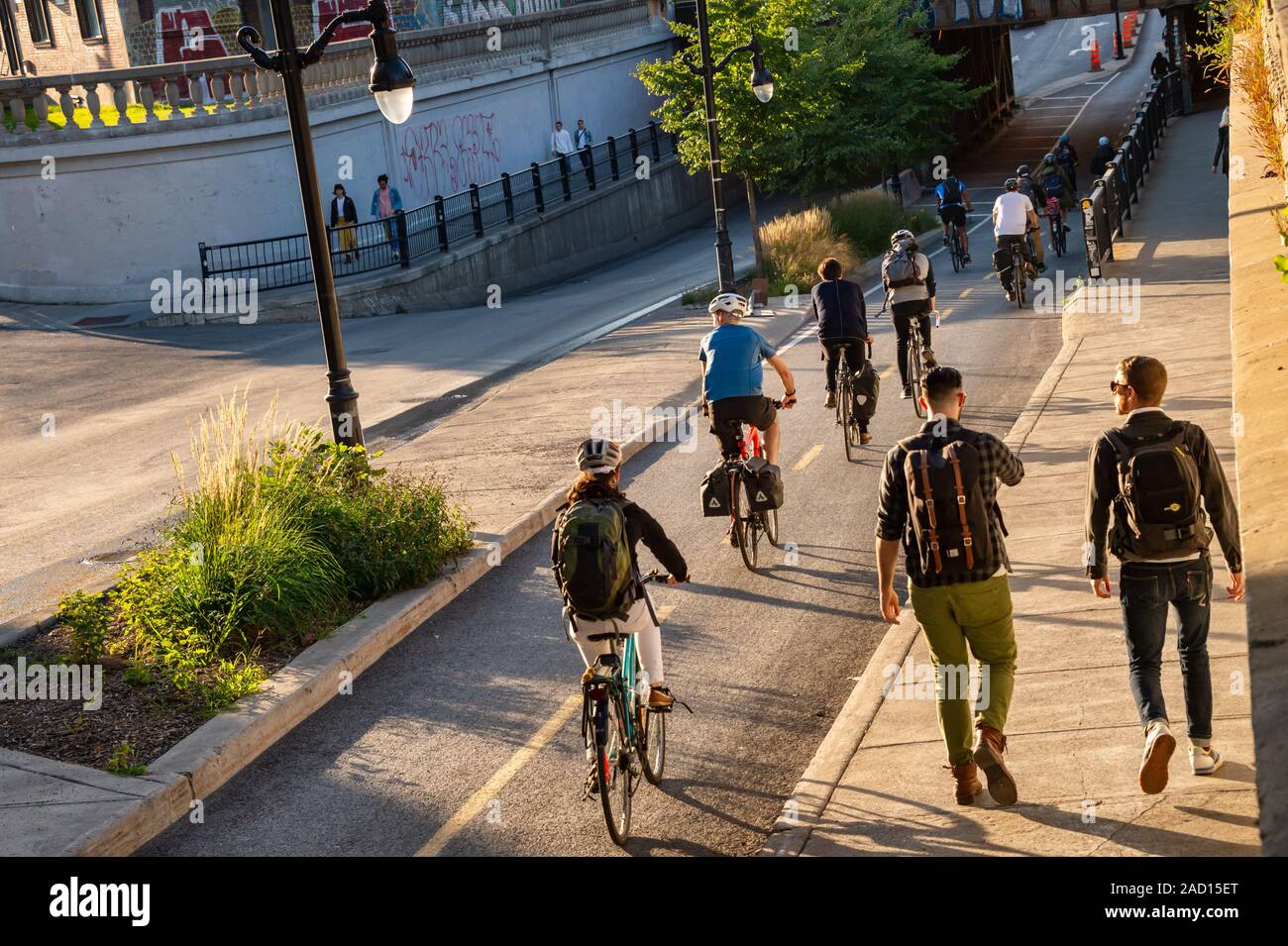 Montreal, Canada - 19 September 2019: People riding bikes on a cycle path, on Saint Laurent Boulevard. Stock Photo