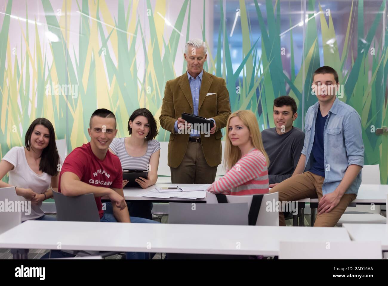 portrait of teacher with students group in background Stock Photo - Alamy