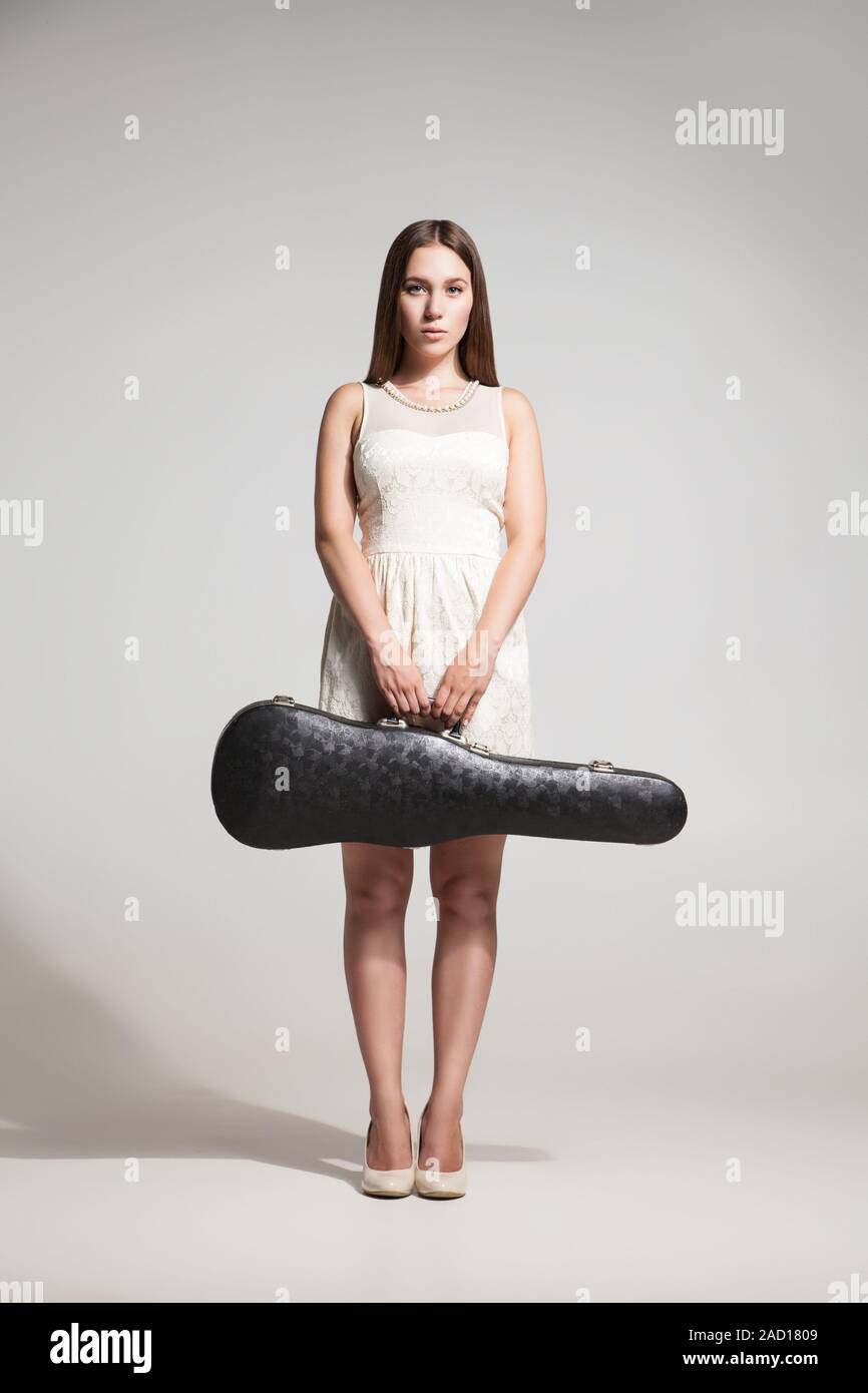 Beautiful woman with violin in case looking at camera Stock Photo - Alamy