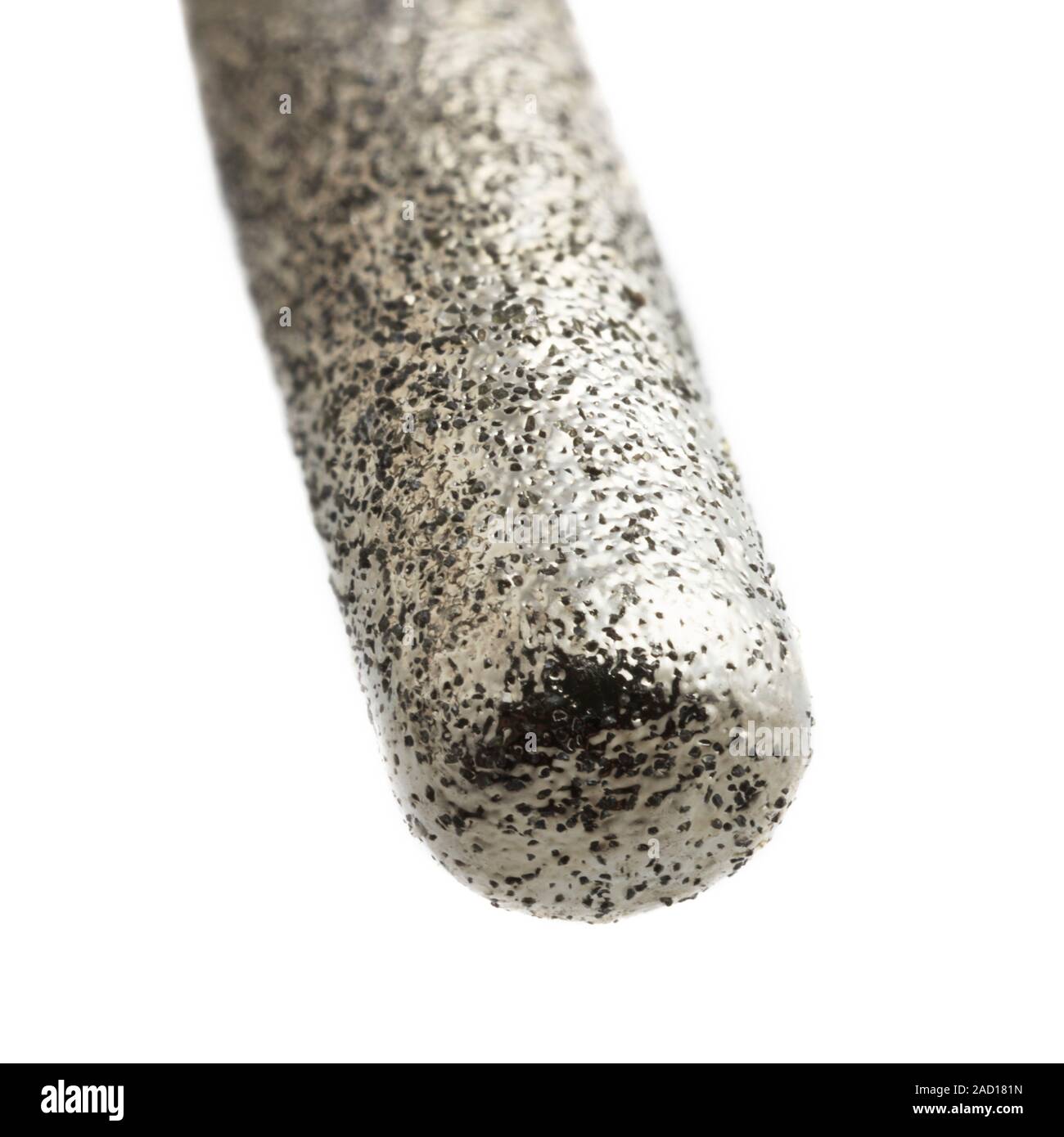 Closeup view of a drill bit encrusted with tiny diamonds. The tiny