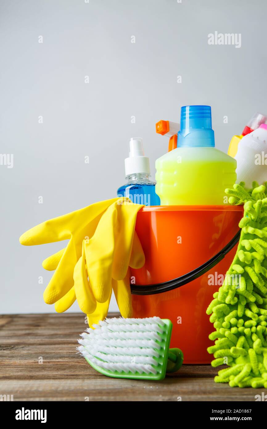 Bucket with cleaning items on light background Stock Photo