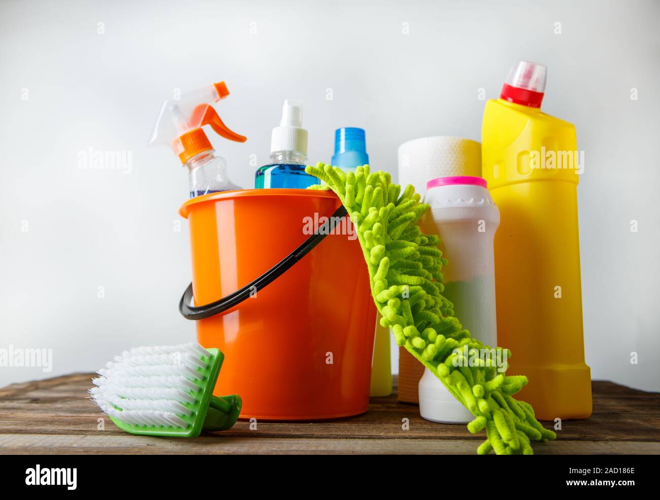 Bucket with cleaning items on light background Stock Photo
