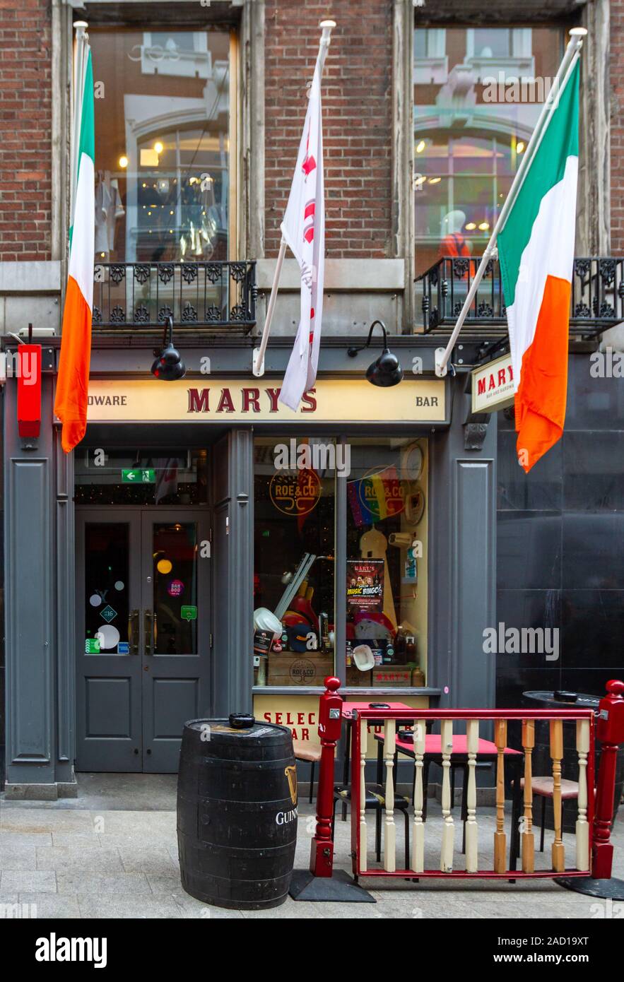 Mary's bar and hardware store, pub, public house and shop in Dublin city, Ireland. Small pub with Irish tricolour tricolor national flags. Marys Stock Photo