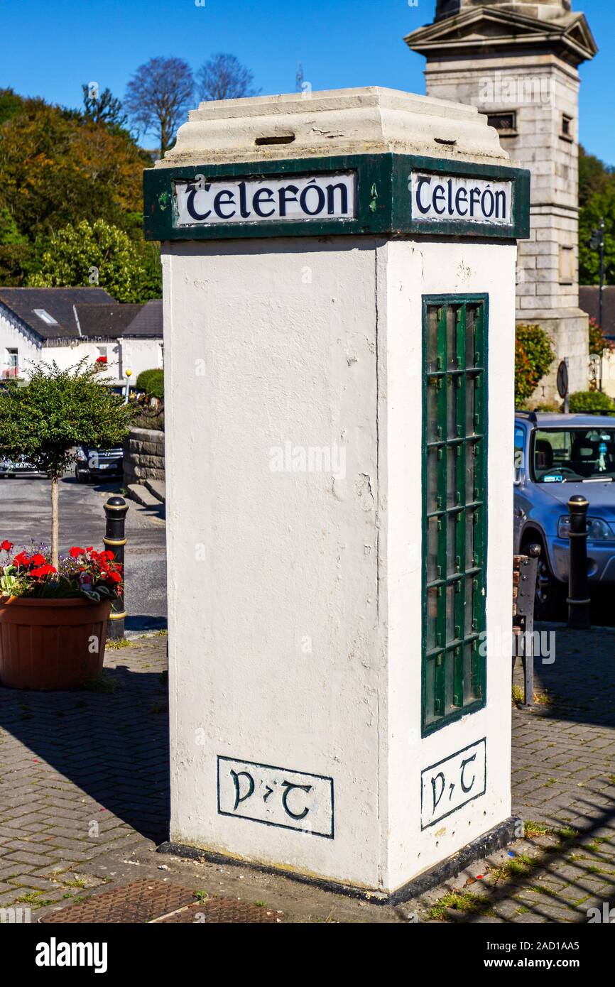 Vintage telephone kiosk, phone box, in Enniskerry village. Old fashioned dial payphone inside. Irish word Telefon on box. Wicklow, Ireland, Europe Stock Photo