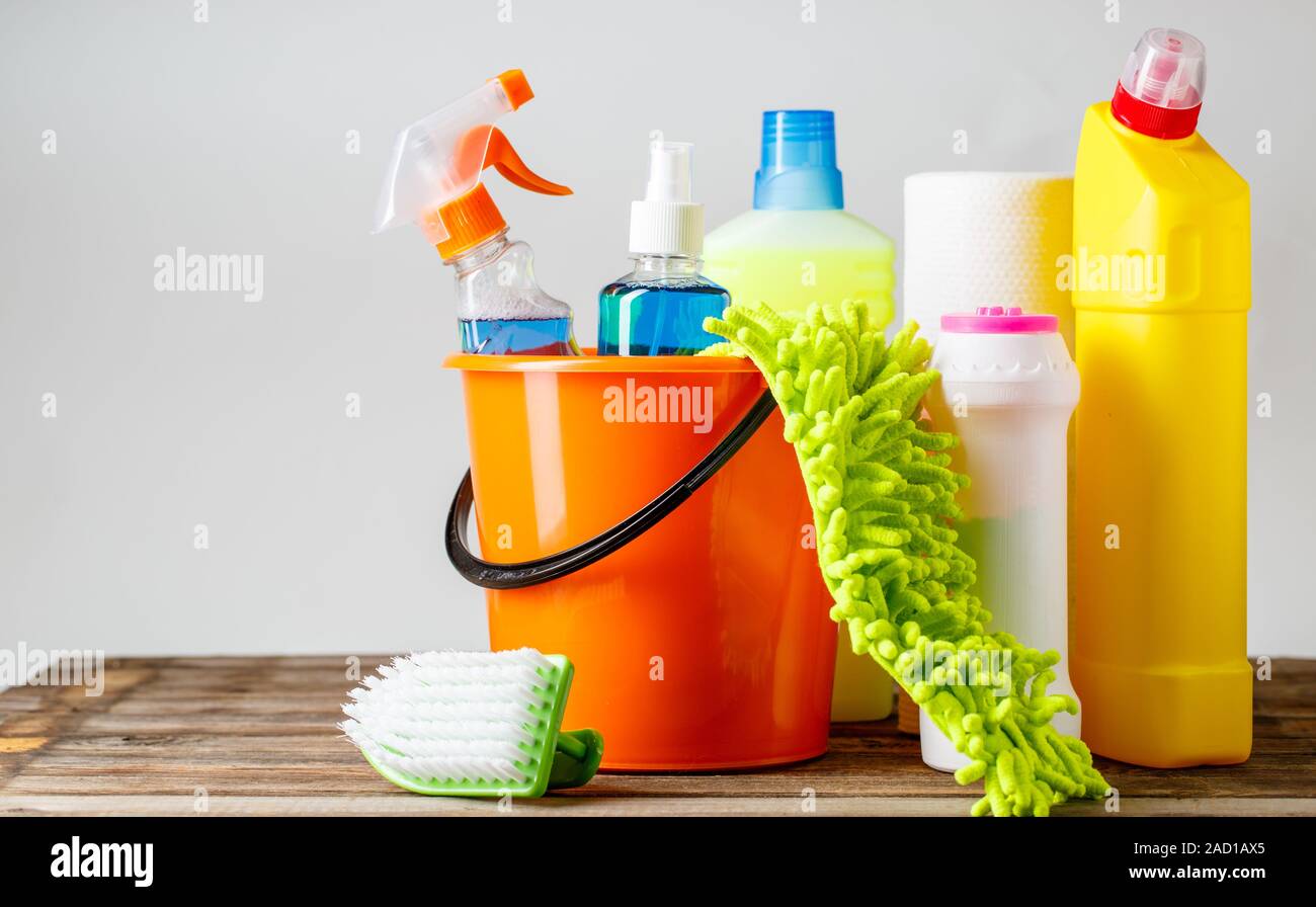 Bucket with cleaning items on light background Stock Photo