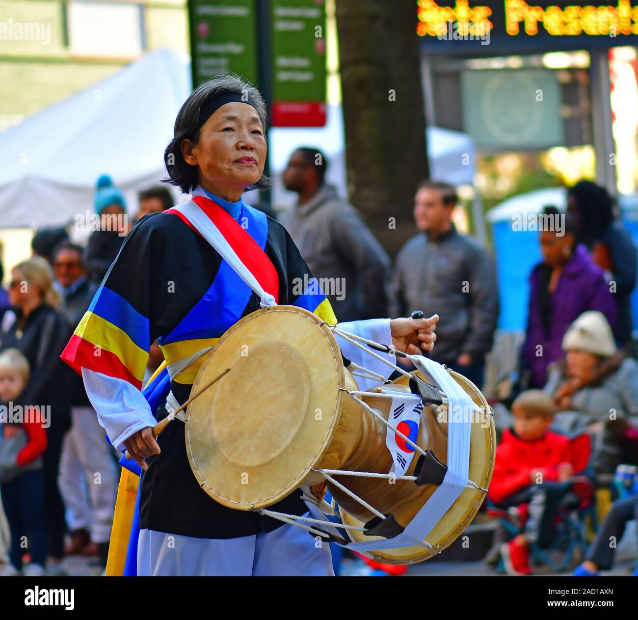 Korean drummers and bandleader marching in the Thanksgiving Day parade in Charlotte NC Stock Photo