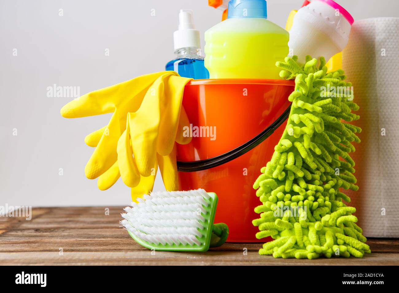 Bucket with cleaning items on light background Stock Photo - Alamy