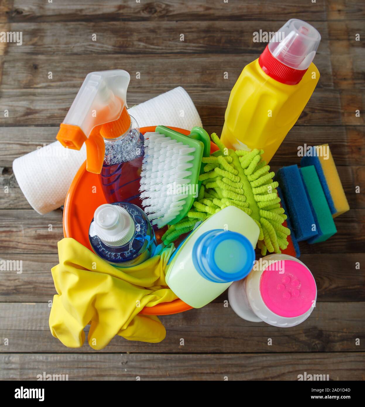 Plastic bucket with cleaning supplies on wood background Stock Photo ...