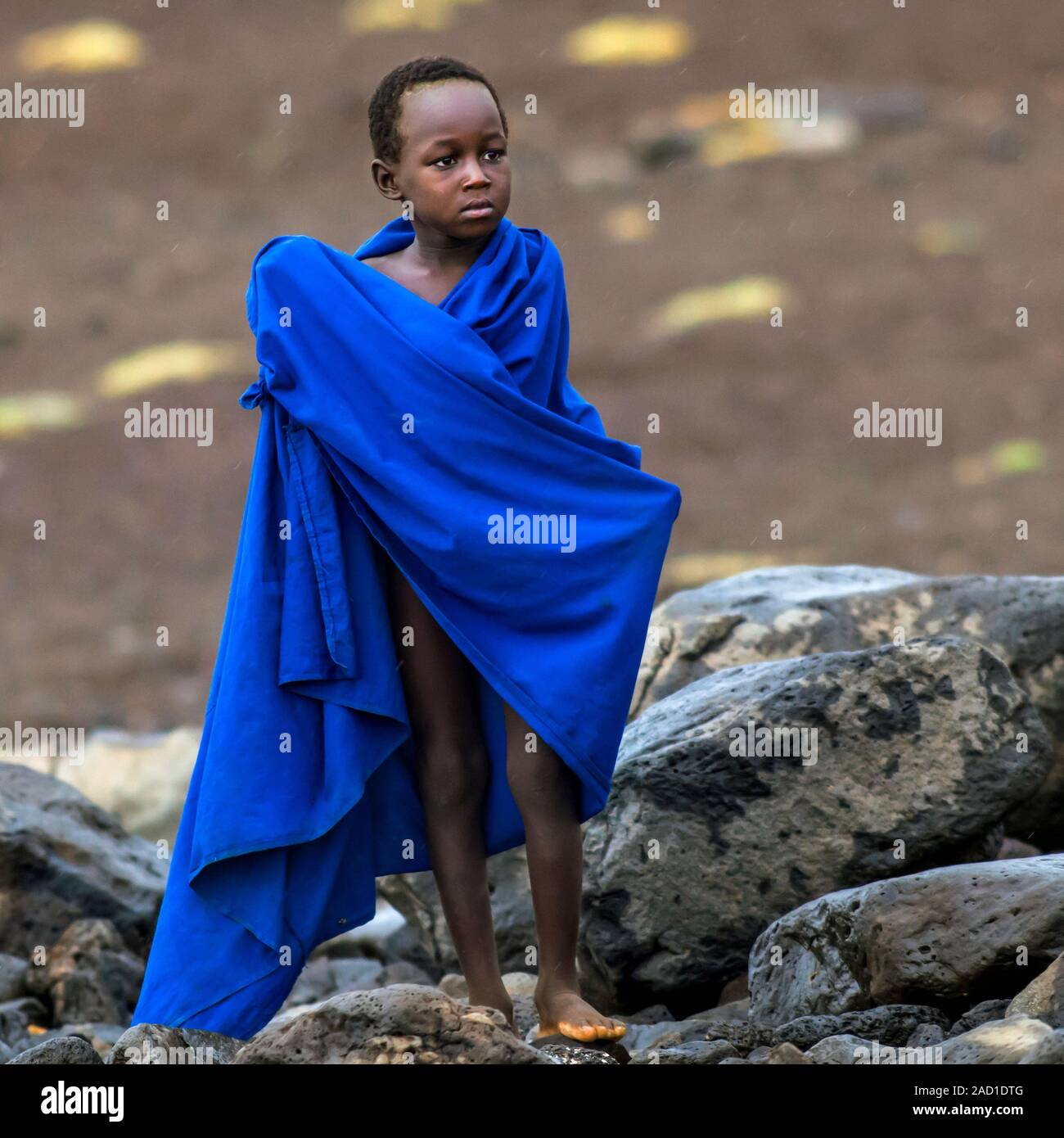 Turkana boy. Young boy from a Turkana tribe wrapped in a blanket. The ...