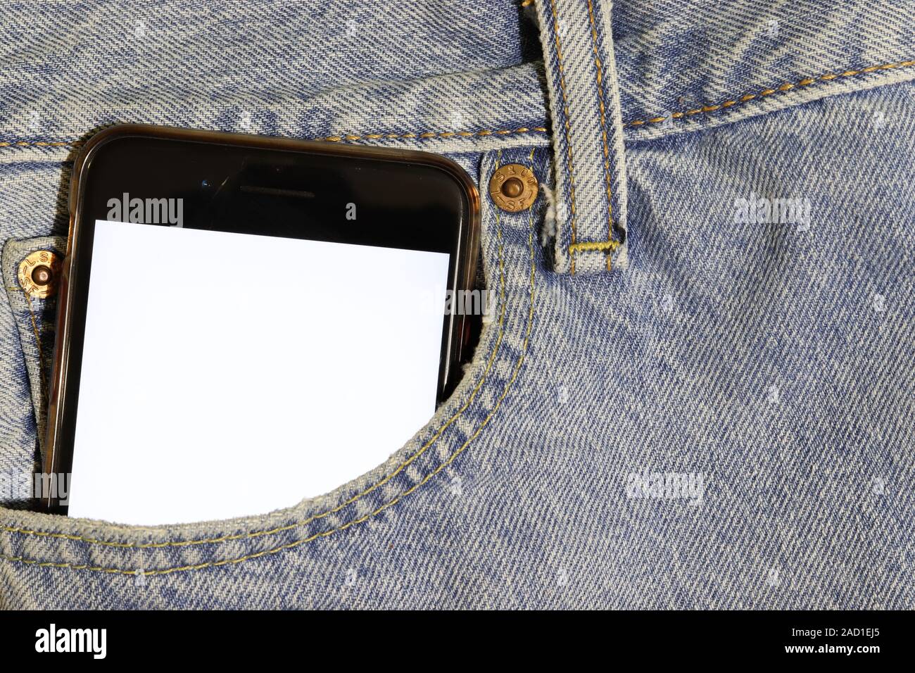 Mock up white screen phone peeping out of the pocket of light blue ...