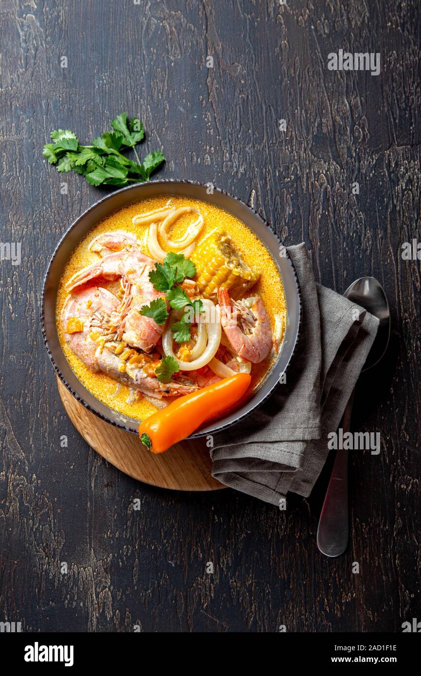 Peruvian seafood soup Chupe de Camarones in gray bowl, top view Stock Photo - Alamy