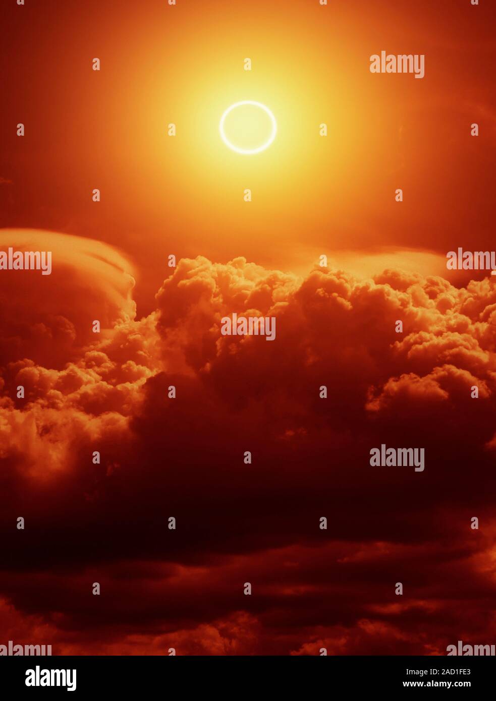 Solar eclipse. View of the Sun in a cloudy sky during an annular solar ...