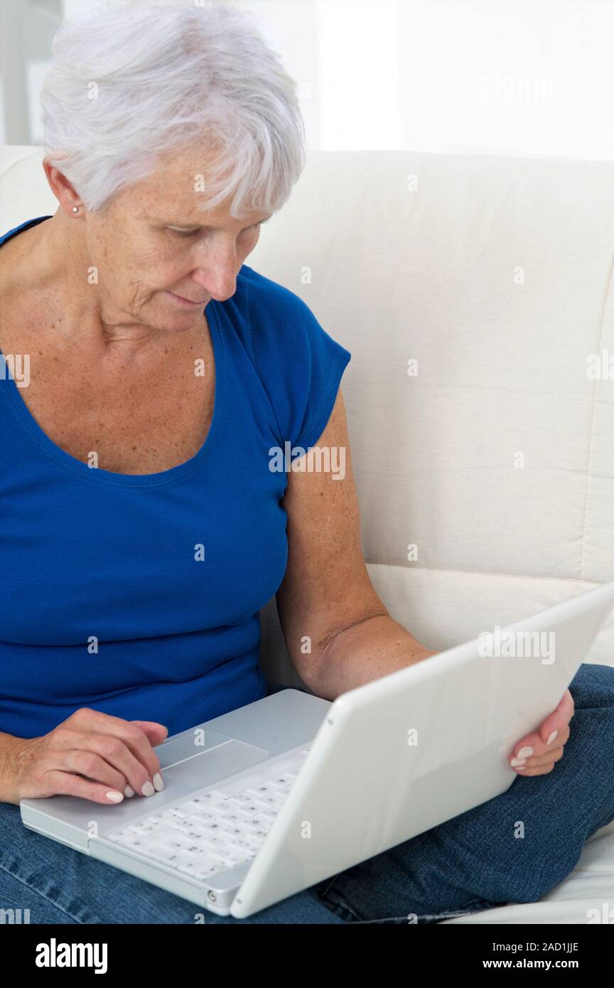 Older lady using laptop. Stock Photo