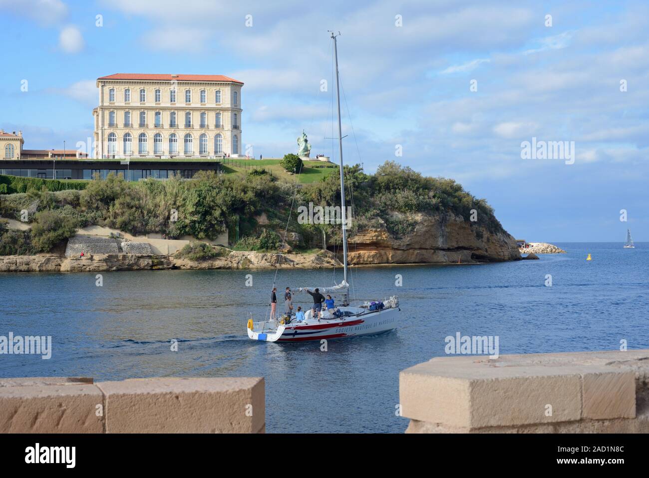Yacht Leaving the Vieux Port, or Old Port, & Palais du Pharo (1858) or Pharo Palace & Garden or Gardens Marseille Provence France Stock Photo