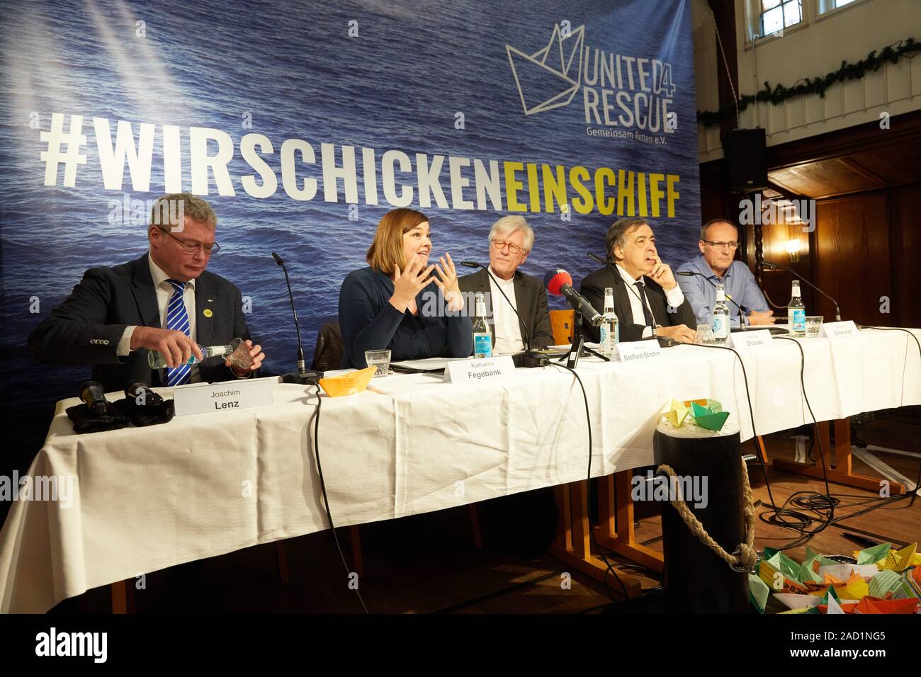 Hamburg, Germany. 03rd Dec, 2019. Joachim Lenz (l-r), Speaker, Katharina Fegebank (Greens), Second Mayor of Hamburg, Heinrich Bedford-Strohm, Bishop of Hamburg, Leoluca Orlando, Mayor of Palermo, and Michael Schwickart, Sea-Watch, a sea rescue specialist, will give a press conference on the new alliance 'United4Rescue - Rescuing together!' at the River Ship's Church. The civil society alliance of churches, municipalities and associations wants to send another ship to the Mediterranean Sea for rescue at sea. Credit: Georg Wendt/dpa/Alamy Live News Stock Photo