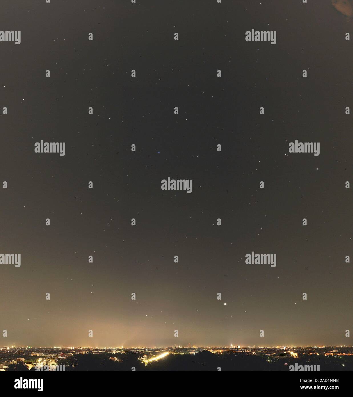 Summer stars and light pollution. View of the night sky over a city ...