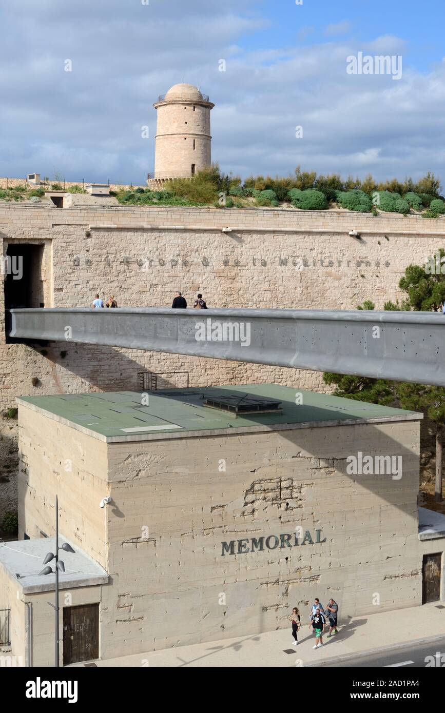 Tourists Crossing Modern Footbridge or Aerial Walkway to Fort Saint Jean, part of the MUCEM Museum, & War Memoriam Museum Marseille Provence France Stock Photo
