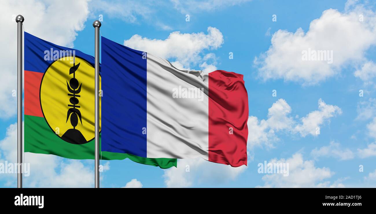 New Caledonia and France flag waving in the wind against white cloudy