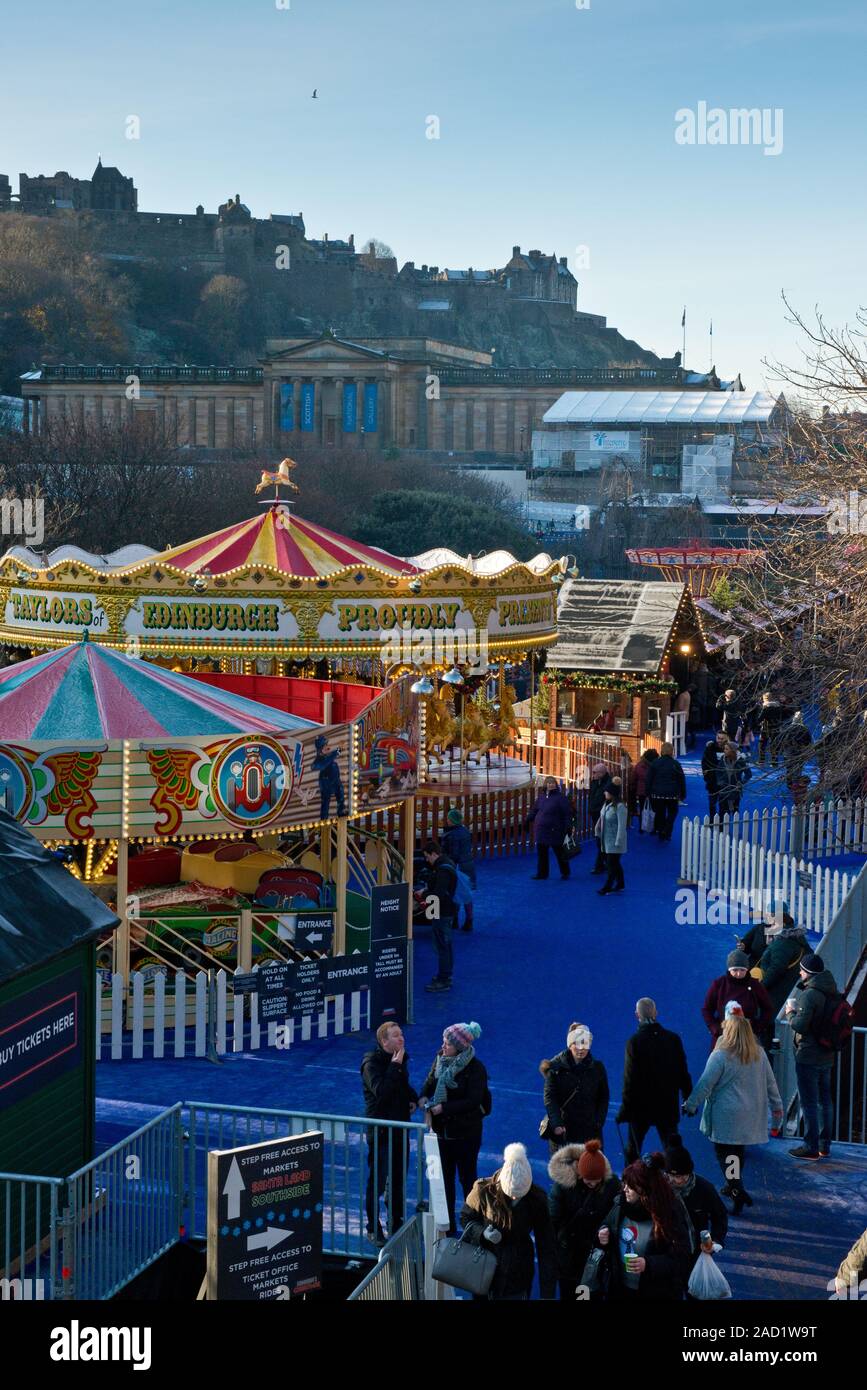 Edinburgh Castle, Christmas Market and Fair. Carousel and market in foreground. Scotland Stock Photo