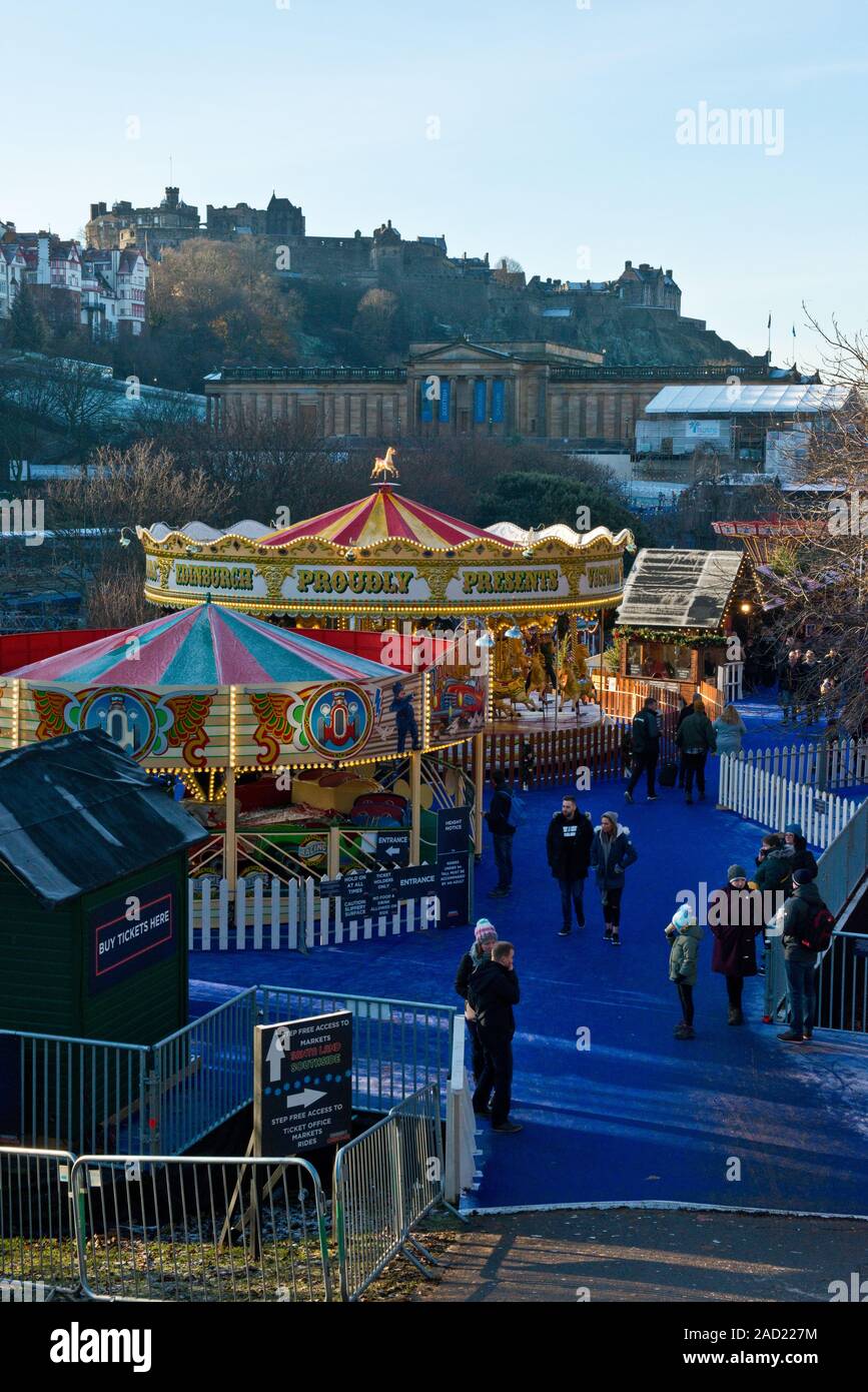 Edinburgh Castle, Christmas Market and Fair. Carousel and market in foreground. Scotland Stock Photo