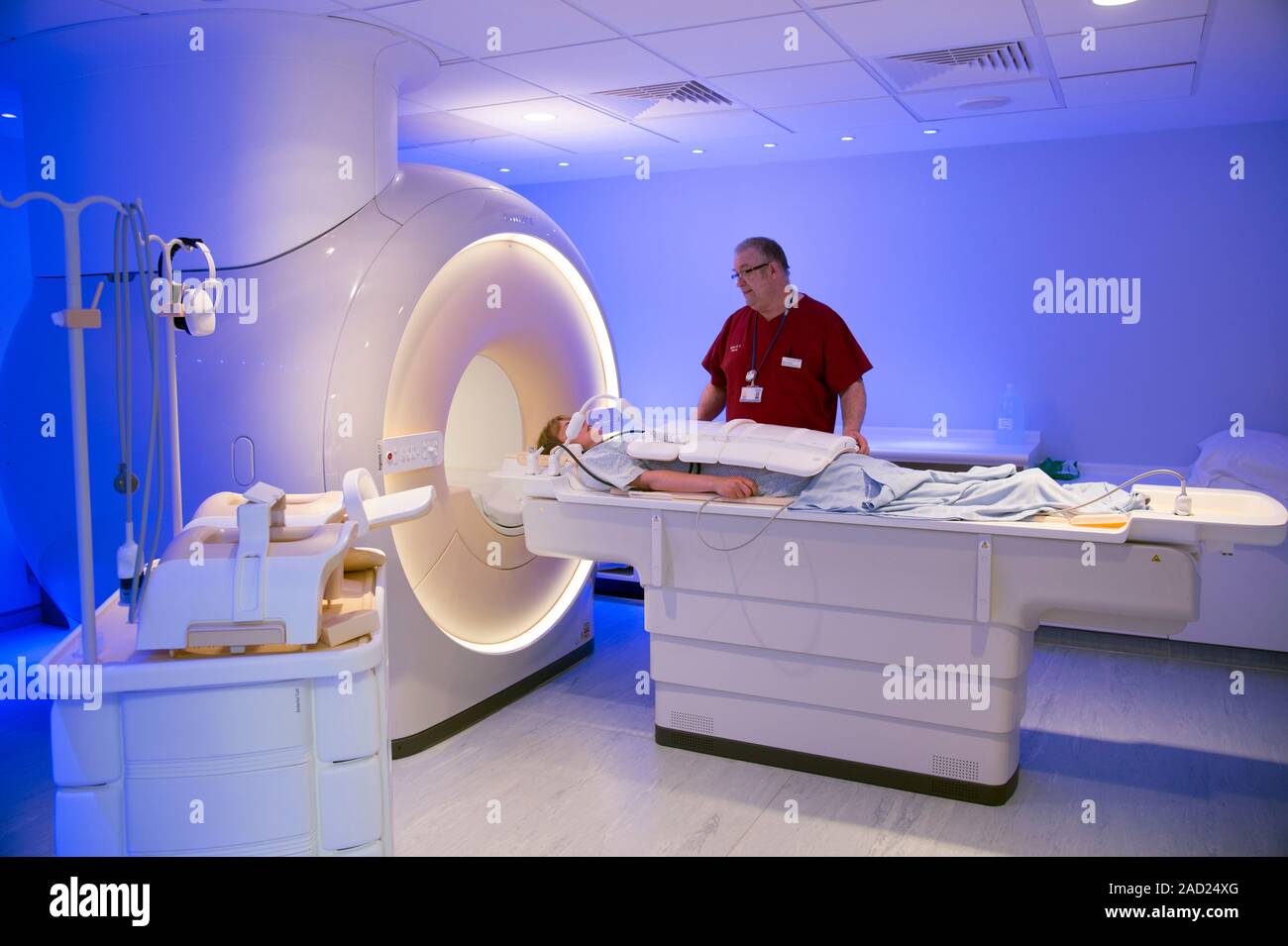 Radiographer preparing an MRI scan. Radiographer talking with a patient ...