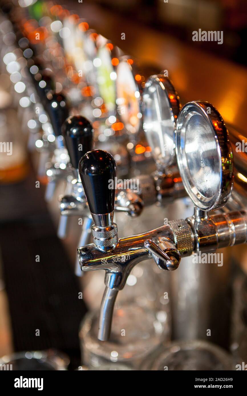 Row of Beer Taps in Bar for different types of drink. Bar interior