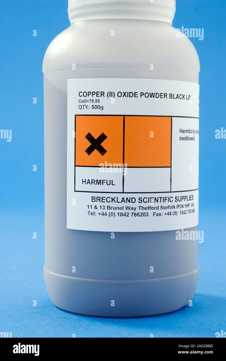 Copper oxide. Bottle containing copper(II) oxide (CuO) powder, showing