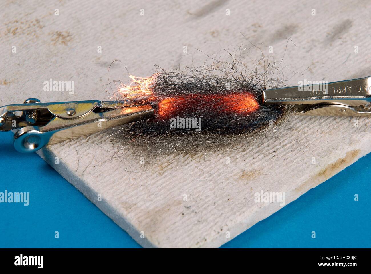 Passing current through steel wool. Closeup of steel wool glowing and