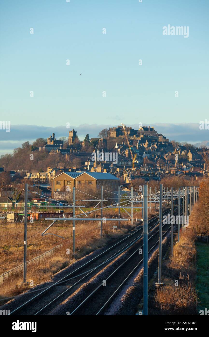 Electrified train tracks leading towards Stirling Castle, Scotland. Stock Photo