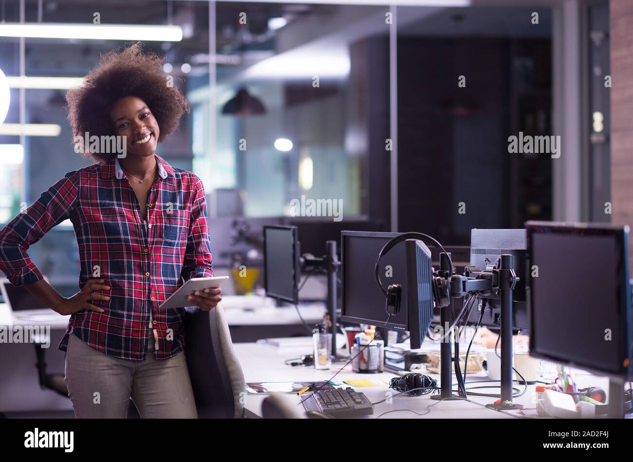 portrait of a young successful African-American woman in modern office ...
