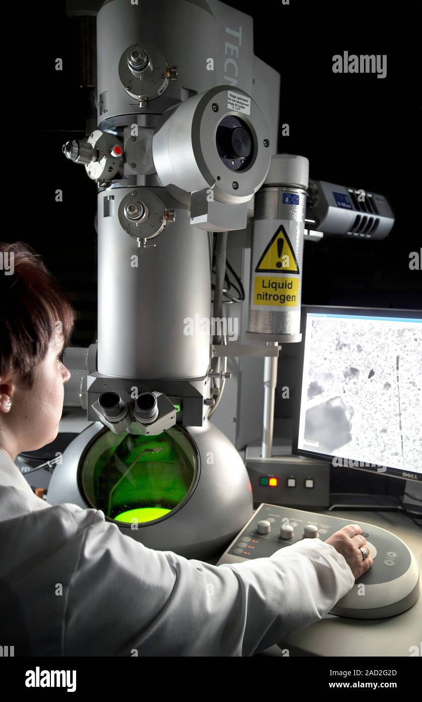 Transmission electron microscopy. Researcher operating a transmission
