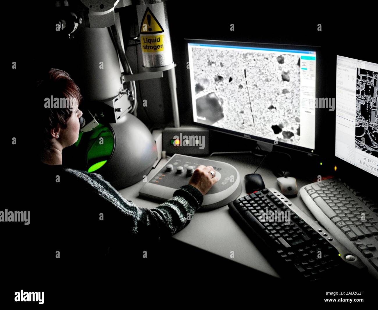 Transmission electron microscopy. Researcher operating a transmission