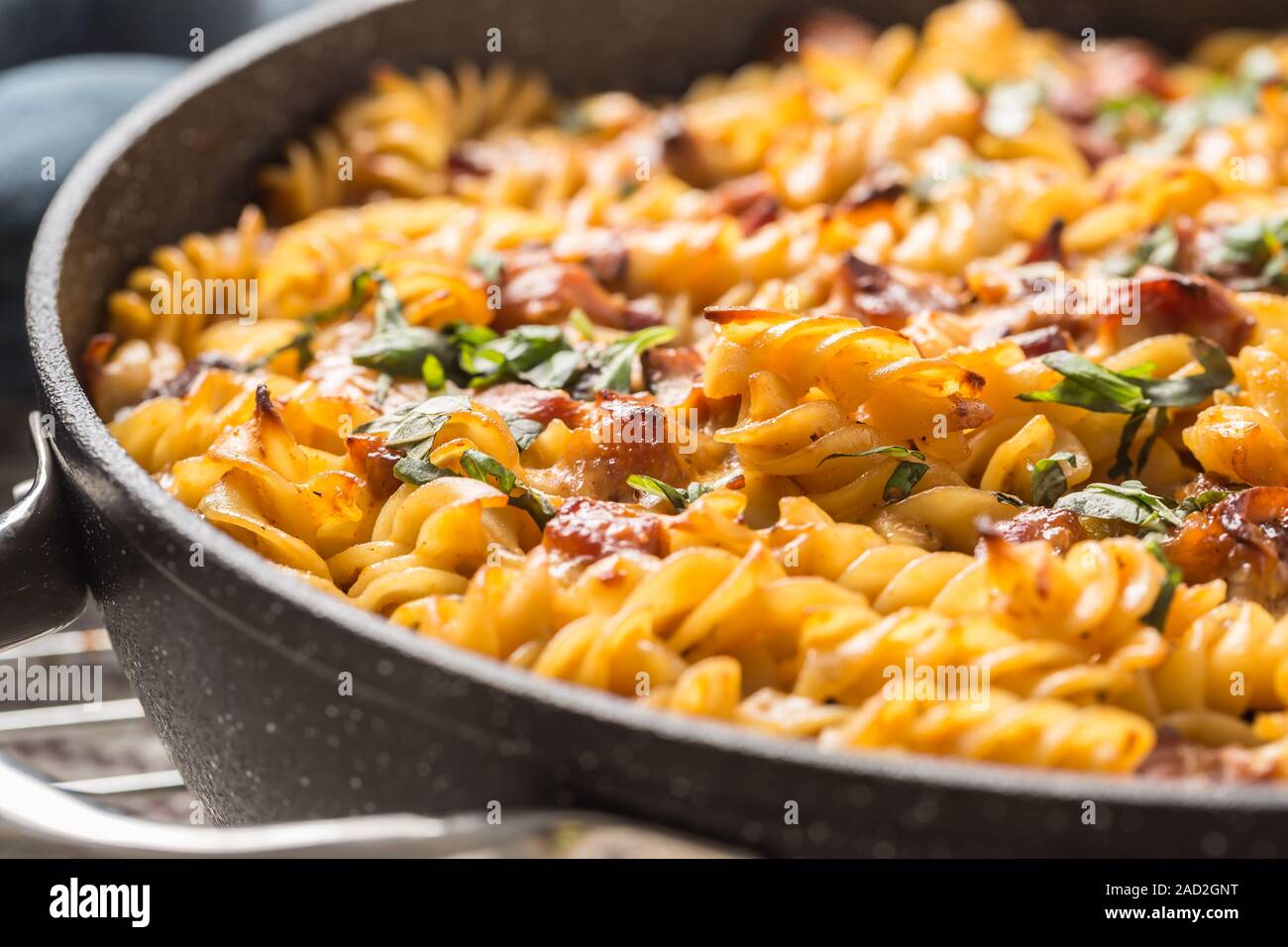 Baked pasta fusilli with smoked pork neck mozzarela cheese and othe ingredients Stock Photo