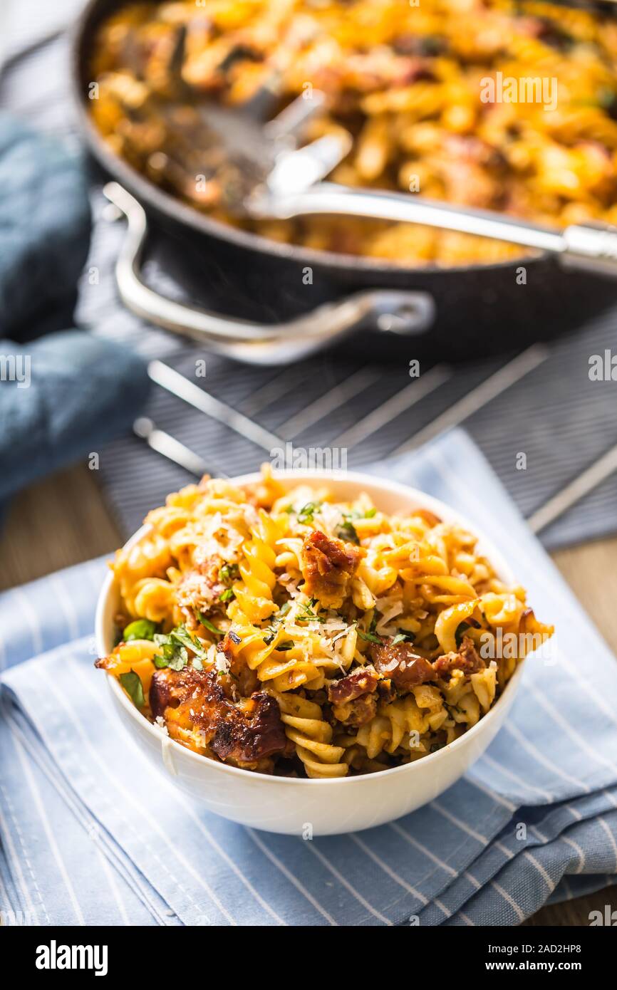 Baked pasta fusilli with smoked pork neck mozzarela cheese and othe ingredients Stock Photo