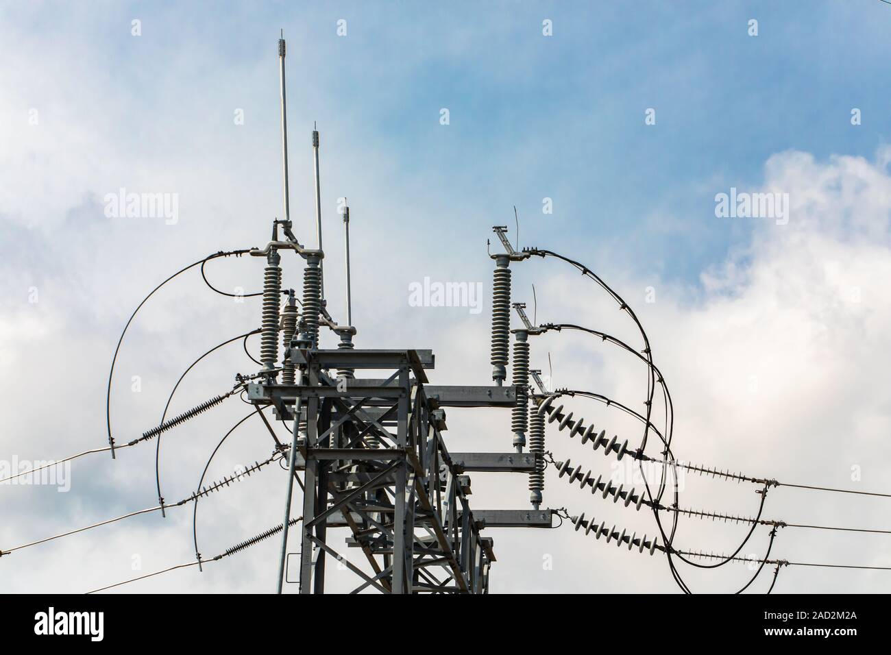 high voltage electrical substation tower with open electrical Isolator or Electrical Isolation Switch, Elements of a substation Stock Photo