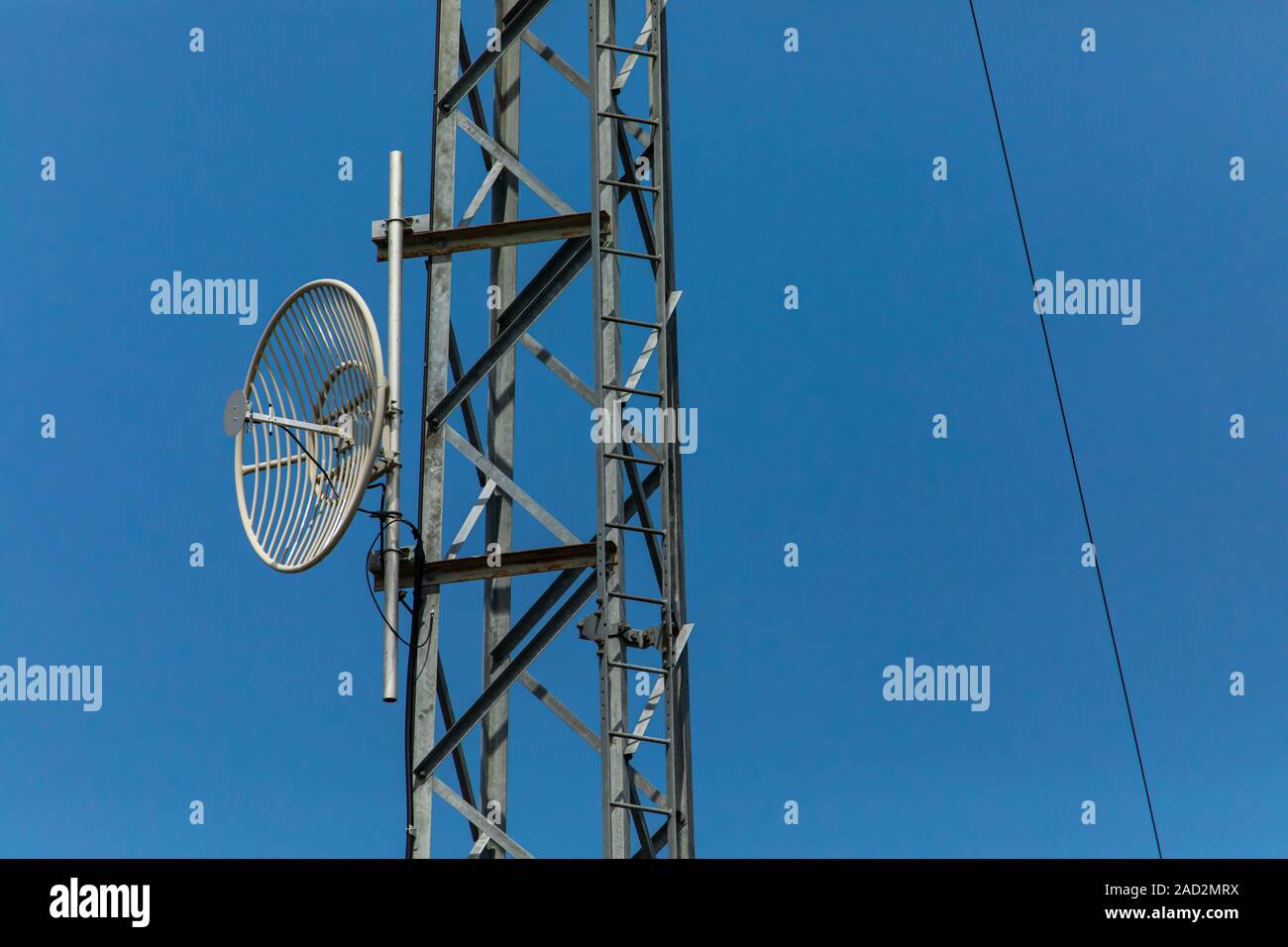 small communication satellite on the tower in an electrical substation, against the sky, Used for remote control and monitoring of the substations Stock Photo