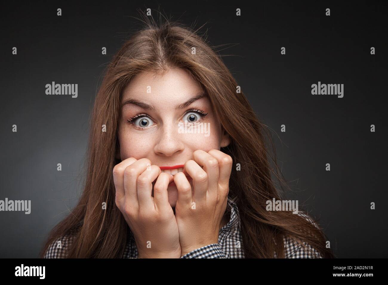 Amazed woman biting nails Stock Photo Alamy