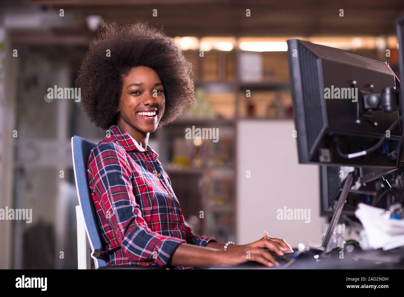 portrait of a young successful African-American woman in modern office ...