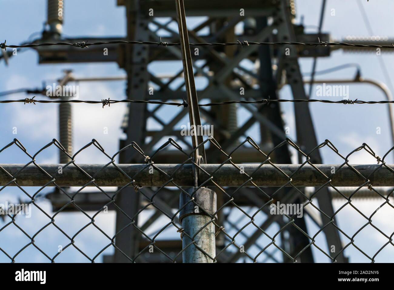 close up on Modern metal fence with barbed wire on the top, high ...