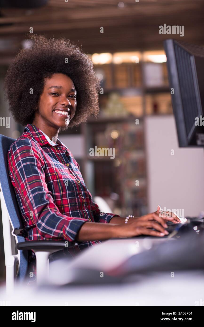 portrait of a young successful African-American woman in modern office ...