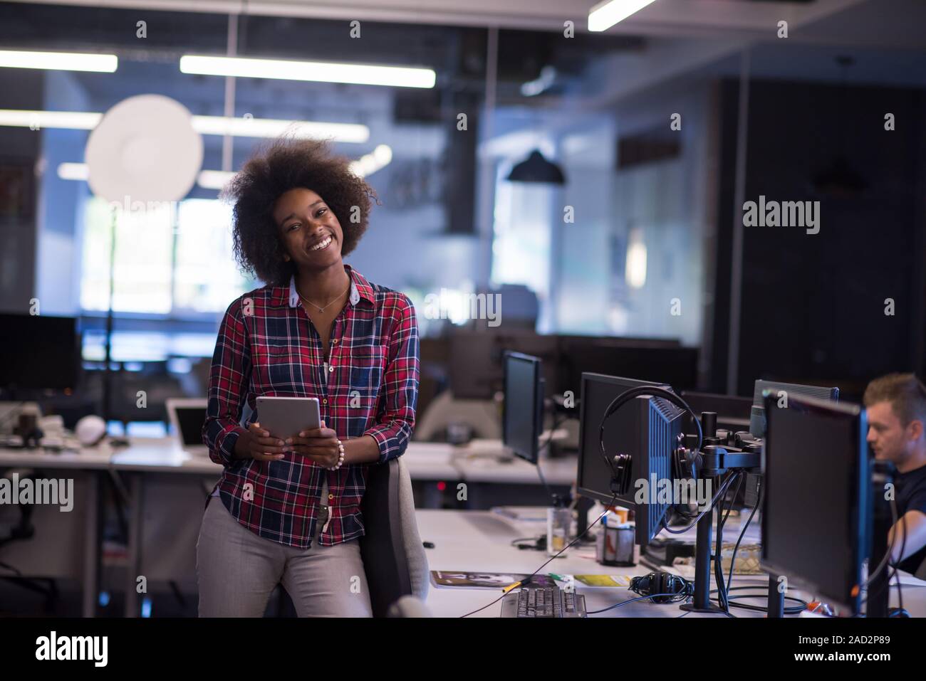 portrait of a young successful African-American woman in modern office ...