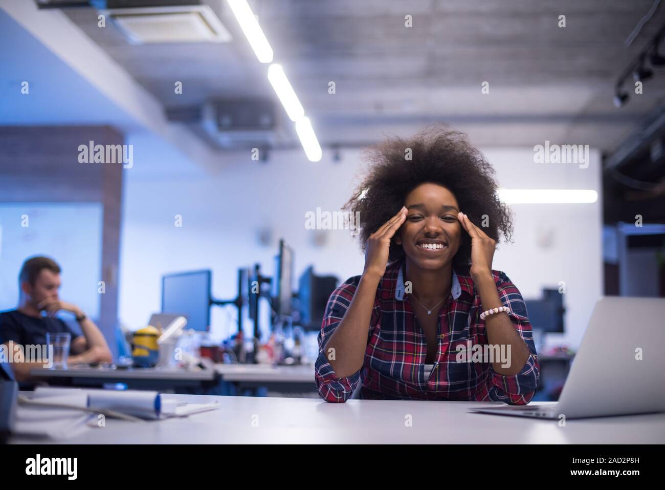 portrait of a young successful African-American woman in modern office ...