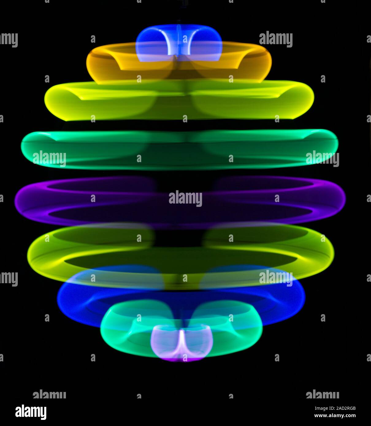 Multicoloured spinning light trails. Stock Photo