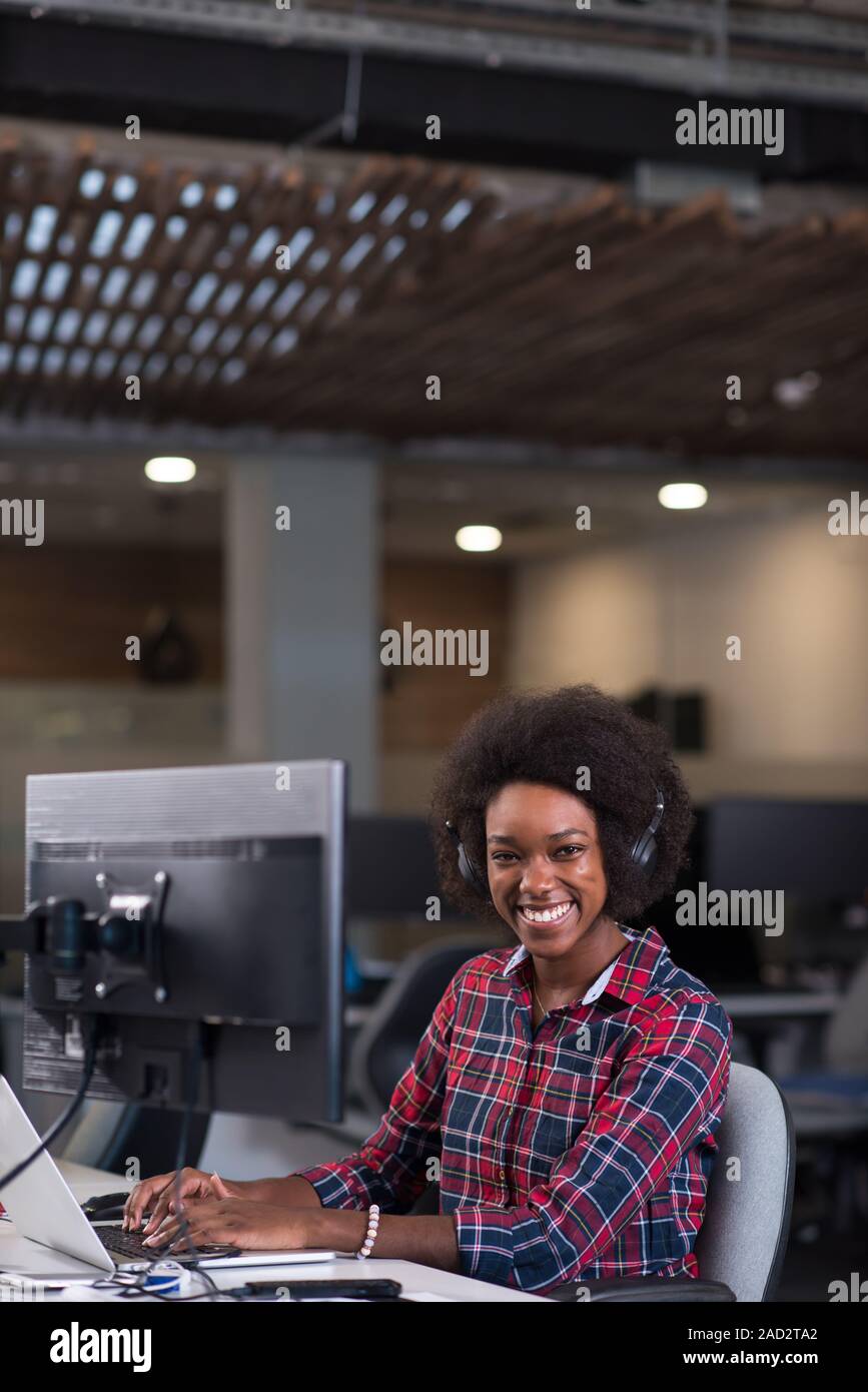 portrait of a young successful African-American woman in modern office ...